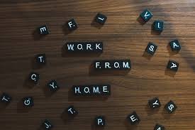 Work from home spelled out in Scrabble letters on wooden desk