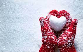 red mittens holding heart-shaped snowball